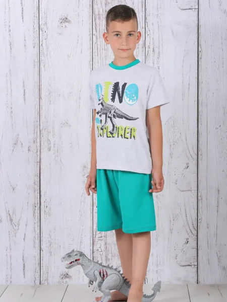 a boy standing next to a toy dinosaur